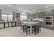 Modern kitchen featuring gray cabinets, stainless steel appliances, and an island with seating at 7153 Grace Estate Ave, Las Vegas, NV 89113