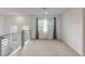 Bright upstairs loft with neutral carpet, modern railing, and plenty of natural light from the large windows at 7153 Grace Estate Ave, Las Vegas, NV 89113