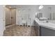 Luxurious main bathroom featuring dual sinks, makeup vanity, and a glass-enclosed shower at 7153 Grace Estate Ave, Las Vegas, NV 89113