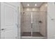 Modern glass-enclosed shower with tiled walls and a rainfall showerhead at 7153 Grace Estate Ave, Las Vegas, NV 89113