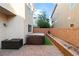 Cozy back patio with brick pavers, sliding glass door access, hot tub, and storage box, perfect for outdoor relaxation at 7253 Sterling Rock Ave, Las Vegas, NV 89178