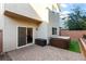 Cozy back patio with brick pavers, sliding glass door access, hot tub, and storage box, perfect for outdoor relaxation at 7253 Sterling Rock Ave, Las Vegas, NV 89178