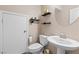 This powder room features tile flooring, a pedestal sink, and decorative shelving at 7253 Sterling Rock Ave, Las Vegas, NV 89178