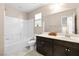 Bathroom with shower/tub combo features a large mirror and a single-sink vanity at 7253 Sterling Rock Ave, Las Vegas, NV 89178