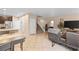 Open concept living room with tile flooring connecting to the kitchen and staircase at 7253 Sterling Rock Ave, Las Vegas, NV 89178