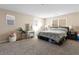 Bright main bedroom with carpet, and large windows features a vanity and closet space at 7253 Sterling Rock Ave, Las Vegas, NV 89178