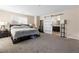 Large main bedroom features a sliding barn door to the ensuite bathroom, and carpet flooring at 7253 Sterling Rock Ave, Las Vegas, NV 89178