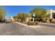 Stone accented neighborhood entrance with lush landscaping and mature trees, creating a welcoming arrival at 7253 Sterling Rock Ave, Las Vegas, NV 89178