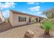 Spacious backyard featuring gravel landscaping, a covered patio, and drought-tolerant vegetation for low-maintenance outdoor space at 7633 Lily Trotter St, North Las Vegas, NV 89084
