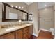 Bathroom boasts dual sinks, granite counters, and a glass-enclosed shower at 7633 Lily Trotter St, North Las Vegas, NV 89084