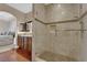 Bathroom featuring tiled walk-in shower and granite vanity; view to bedroom at 7633 Lily Trotter St, North Las Vegas, NV 89084