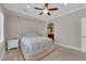 Serene bedroom with plush carpet, ceiling fan, and views to ensuite bathroom at 7633 Lily Trotter St, North Las Vegas, NV 89084