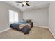 Comfortable carpeted bedroom with ample natural light and modern ceiling fan at 7633 Lily Trotter St, North Las Vegas, NV 89084