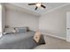 Relaxing bedroom featuring neutral walls, carpet floors, and a cozy bed with decorative pillows and ceiling fan at 7633 Lily Trotter St, North Las Vegas, NV 89084
