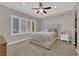 Bright bedroom featuring large windows and a plush upholstered headboard at 7633 Lily Trotter St, North Las Vegas, NV 89084