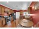 Inviting kitchen with stainless steel appliances, dining area, and wood cabinets at 7633 Lily Trotter St, North Las Vegas, NV 89084