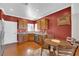 Kitchen features stainless steel appliances, granite countertops, a dining area, and red painted walls at 7633 Lily Trotter St, North Las Vegas, NV 89084