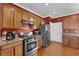 The kitchen features stainless steel appliances, granite countertops, ample wooden cabinets, and a gas range at 7633 Lily Trotter St, North Las Vegas, NV 89084