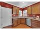 Cozy kitchen features wood cabinets, granite countertops, and stainless steel dishwasher at 7633 Lily Trotter St, North Las Vegas, NV 89084