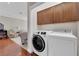 Laundry room with washer, dryer and overhead cabinet storage at 7633 Lily Trotter St, North Las Vegas, NV 89084
