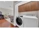 Convenient laundry room with washer, dryer, and upper cabinets at 7633 Lily Trotter St, North Las Vegas, NV 89084