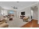 Comfortable living room features neutral carpet, sliding glass door, and ceiling fan at 7633 Lily Trotter St, North Las Vegas, NV 89084