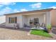Covered patio with outdoor seating, overlooking the serene, low-maintenance landscaped backyard and gravel at 7633 Lily Trotter St, North Las Vegas, NV 89084