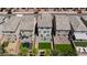 A scenic aerial view of three houses showcasing backyard landscaping, patio furniture, and proximity to neighbors at 7665 Sandhaven St, Las Vegas, NV 89139