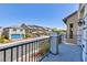 Charming balcony with wrought iron railing, offering views of the neighborhood and blue skies at 7665 Sandhaven St, Las Vegas, NV 89139