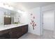 Modern bathroom featuring a double sink vanity and decorative floral accents at 7665 Sandhaven St, Las Vegas, NV 89139