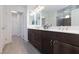 Modern bathroom featuring dual sinks, granite countertops, and a separate walk-in shower at 7665 Sandhaven St, Las Vegas, NV 89139