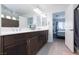 Stylish bathroom showcasing dual sinks, granite countertops, and an open doorway to the bedroom at 7665 Sandhaven St, Las Vegas, NV 89139