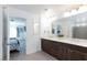 Bathroom featuring a double sink vanity, with a bedroom and walk-in shower in view at 7665 Sandhaven St, Las Vegas, NV 89139