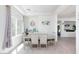 A spacious dining room with a glass table and six chairs complements the natural light from the window at 7665 Sandhaven St, Las Vegas, NV 89139