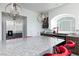 Granite kitchen island with stainless steel appliances and barstool seating, with overhead lighting at 7665 Sandhaven St, Las Vegas, NV 89139