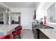 Open kitchen featuring granite countertops, stainless appliances, and a modern pendant light fixture at 7665 Sandhaven St, Las Vegas, NV 89139