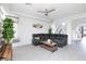 Comfortable living room area with a grey leather couch, side tables, and bright natural lighting at 7665 Sandhaven St, Las Vegas, NV 89139