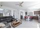 Open concept living space with a living room, kitchen island with stools, and staircase at 7665 Sandhaven St, Las Vegas, NV 89139