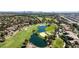 Scenic aerial shot of a golf course community with water feature and lush landscaping; skyline visible in the distance at 7999 Pinnacle Peak Ave, Las Vegas, NV 89113