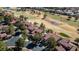 Neighborhood aerial view of red tiled roofs and backyards, close to a golf course at 7999 Pinnacle Peak Ave, Las Vegas, NV 89113