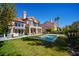 Expansive backyard featuring a pool, lush lawn, and patio area perfect for outdoor relaxation and entertaining at 7999 Pinnacle Peak Ave, Las Vegas, NV 89113