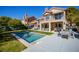 Backyard view of home with a private pool, seating area, and manicured lawn at 7999 Pinnacle Peak Ave, Las Vegas, NV 89113