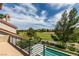 Enjoy the view of the lush golf course from this home's balcony, complete with a sparkling pool below at 7999 Pinnacle Peak Ave, Las Vegas, NV 89113