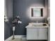 Modern powder room with floating vanity, vessel sink, unique lighting, and stylish gray wallpaper at 7999 Pinnacle Peak Ave, Las Vegas, NV 89113