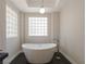 Spa-like bathroom with standalone tub and geometric glass block window for natural light at 7999 Pinnacle Peak Ave, Las Vegas, NV 89113