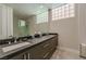 Modern bathroom with a double vanity, shower, and sleek fixtures and finishes at 7999 Pinnacle Peak Ave, Las Vegas, NV 89113