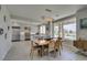 Dining area with a live-edge wood table, stylish light fixture, and view to kitchen at 7999 Pinnacle Peak Ave, Las Vegas, NV 89113