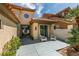 Inviting front exterior with desert landscaping and a covered patio area with seating at 7999 Pinnacle Peak Ave, Las Vegas, NV 89113