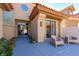 Inviting front entrance with a tiled roof, modern chairs, and large windows, creating a welcoming ambiance at 7999 Pinnacle Peak Ave, Las Vegas, NV 89113