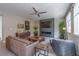 Living room features a ceiling fan, fireplace, tile flooring, and comfortable seating, perfect for relaxing or entertaining at 7999 Pinnacle Peak Ave, Las Vegas, NV 89113